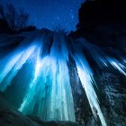 Ethereal scene of blue lights over jagged peaks