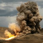 Massive desert explosion with fiery plumes and thick smoke billows