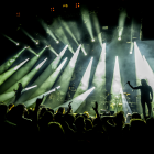 Silhouetted People in Cavernous Space with Light Shafts