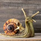 Grotesque Halloween masks with horns and sharp teeth on wooden table