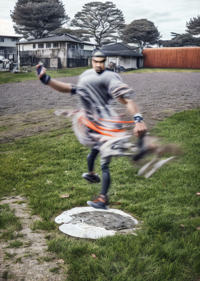 Person swinging baseball bat on manhole cover in grassy field