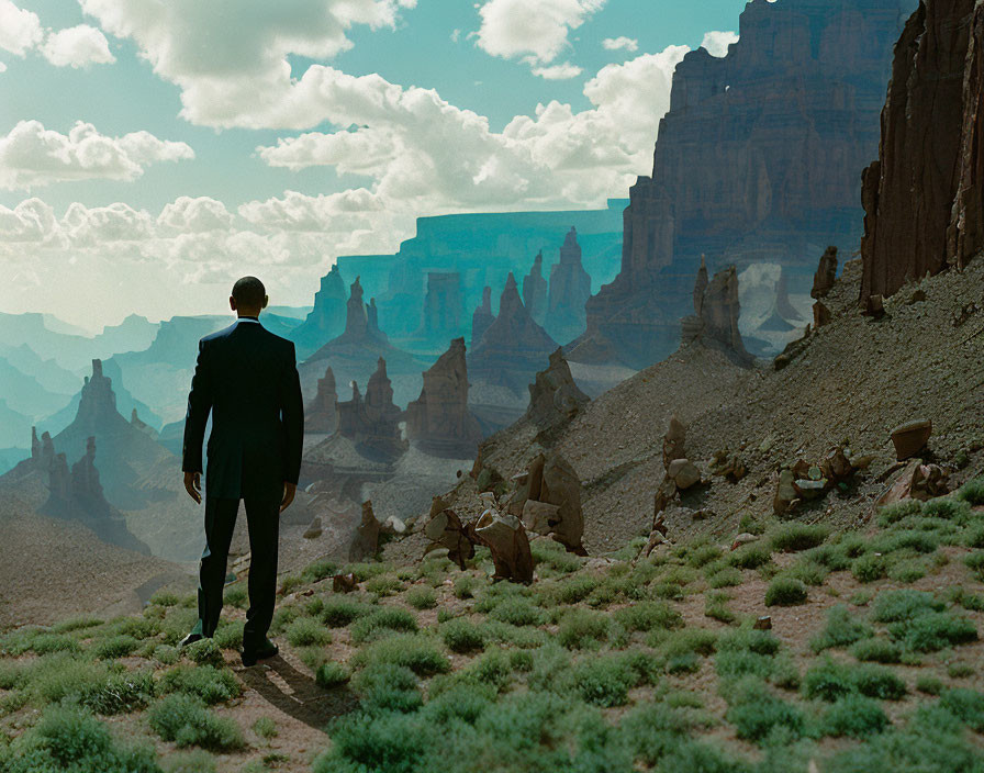 Business person in suit in desert landscape with rocky formations under blue sky.