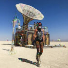 Steampunk robot standing in desert with futuristic structures