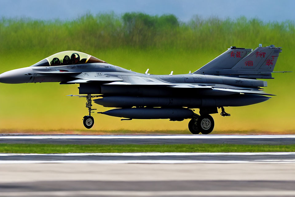 Military fighter jet with external payloads on runway, blurred background, Chinese characters on tail.