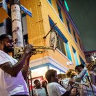 Brass musicians playing trumpet and trombone on vibrant street