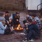 Traditional Gathering Around Fire Cooking and Sharing Meal Illustration