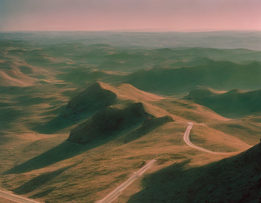 Winding Road Through Green Hills at Dusk