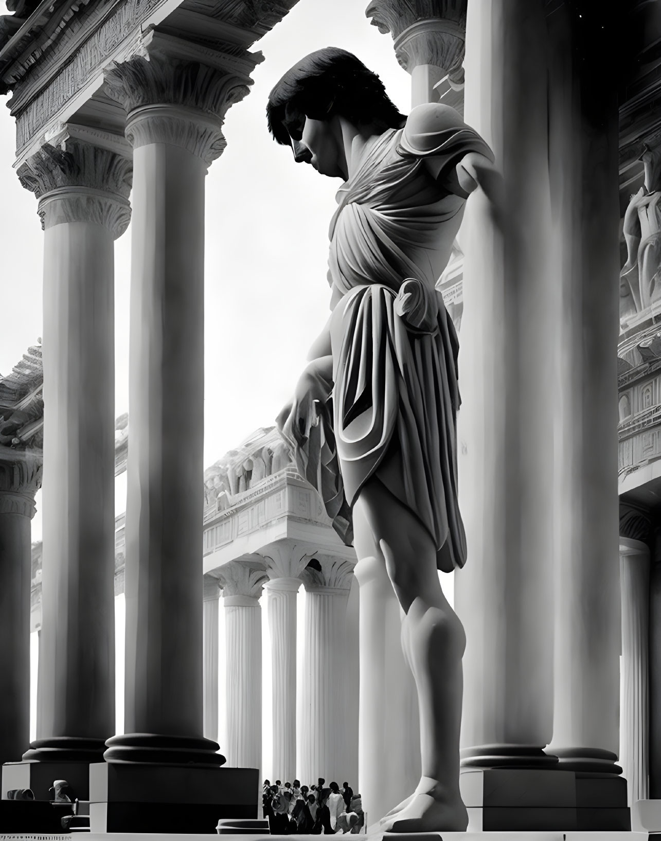 Monochrome image of colossal robed statue with onlookers and columns