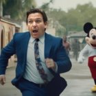 Man in Blue Suit Running with Surprised Expression Next to Mickey Mouse in Street Setting