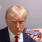 Exaggerated frown on person with "GIMMEHES" candy bar