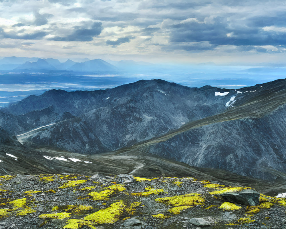 Rocky Mountain Peaks with Snow Patches and Vibrant Yellow Lichen