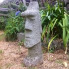 Gigantic stone statue overseeing tribal warriors and landscape