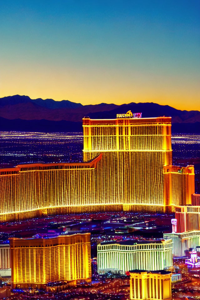 Golden hotel shines in Las Vegas twilight skyline