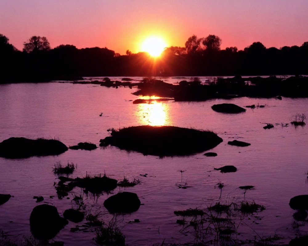 Tranquil river sunset with scattered rocks and islands