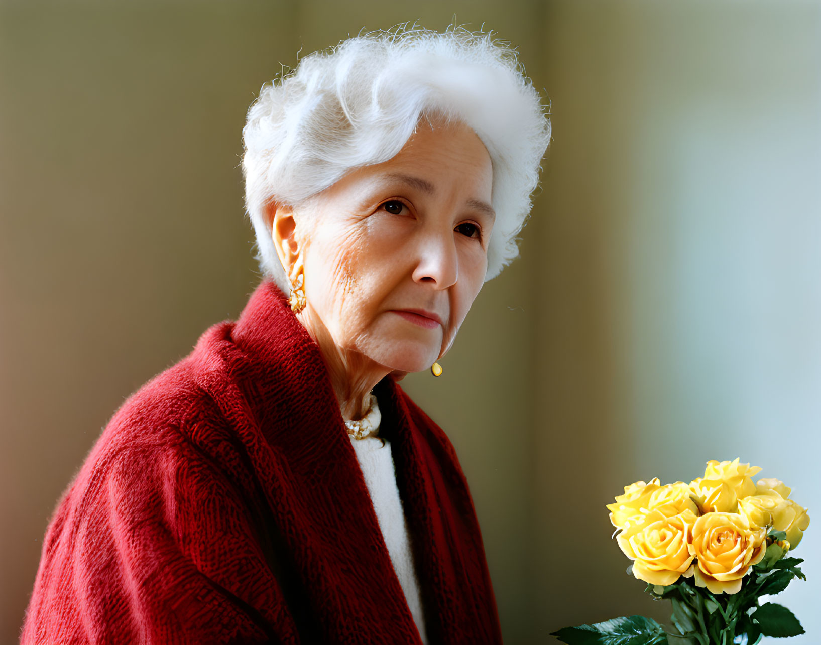 Elderly Woman with White Hair and Red Cardigan Beside Yellow Roses