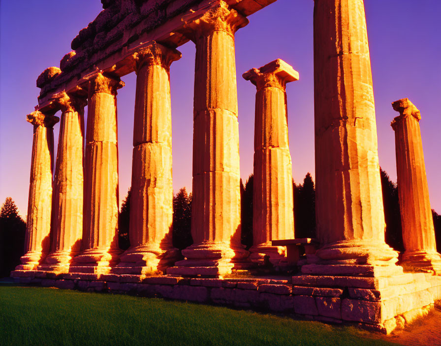 Ancient Greek columns under vibrant purple and orange sunset sky