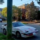 Desolate Street with Abandoned Cars and Derelict Buildings in Morning Light