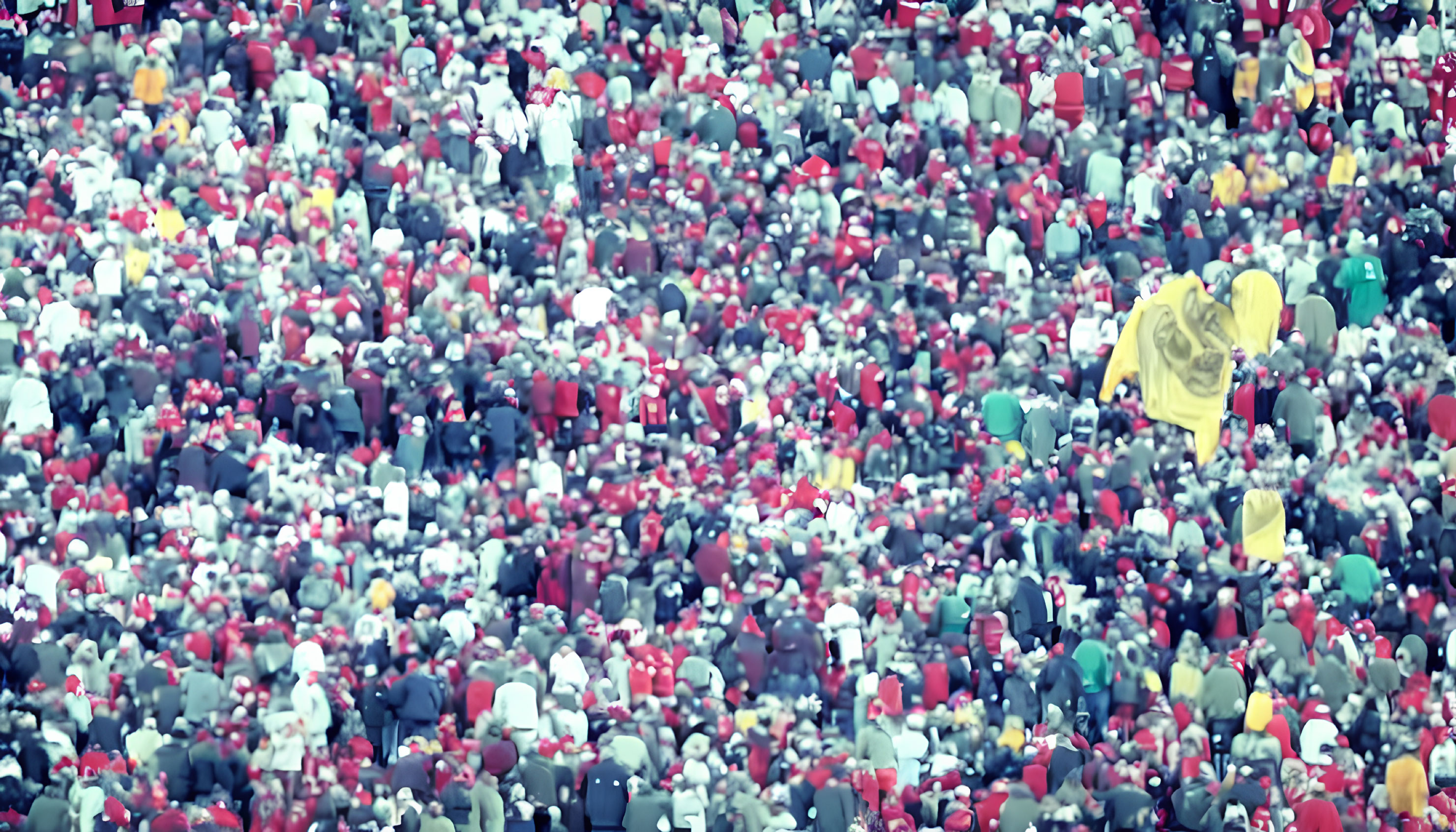 Crowd of people in red and yellow raincoats from afar