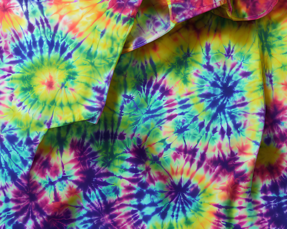 Colorful Tie-Dye Fabric with Circular Patterns in Blue, Green, Yellow, and Pink