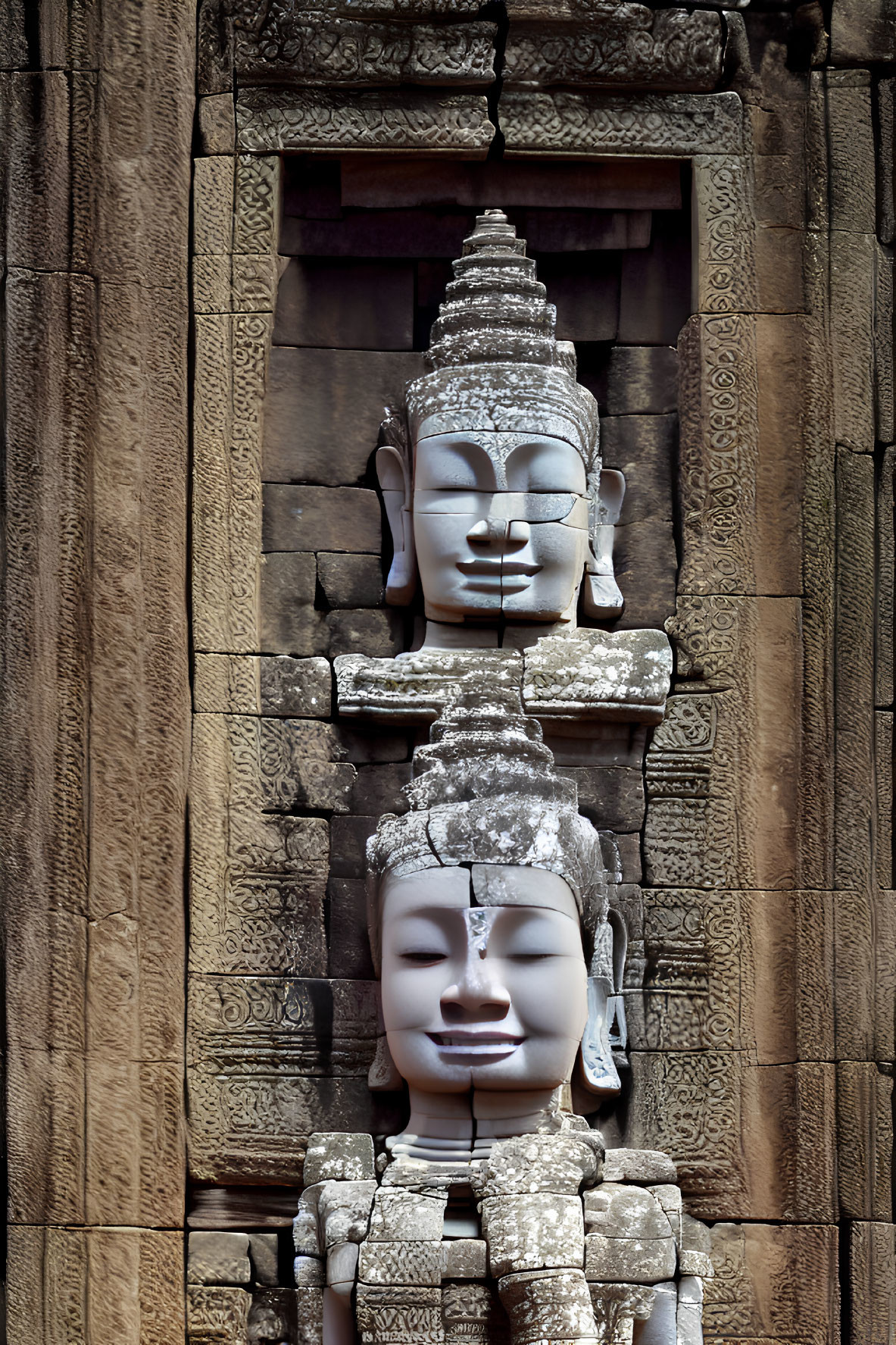 Intricate stone faces and patterns at Bayon Temple