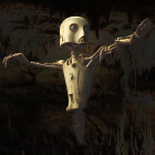 Rusty humanoid robot with expressive face against corroded wall