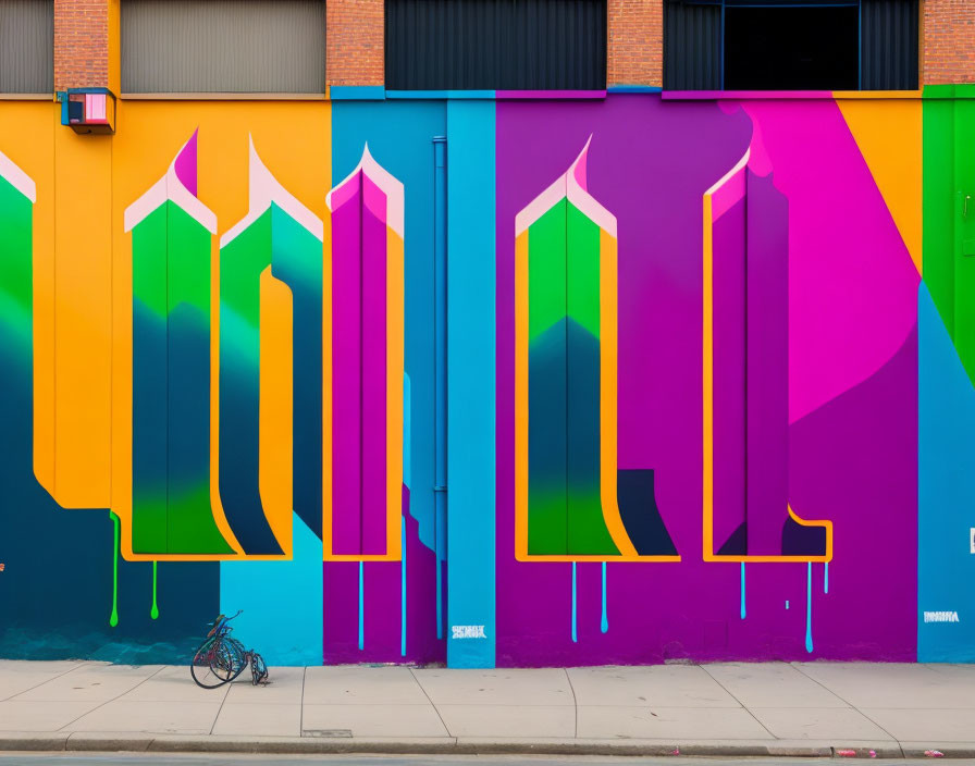 Colorful street mural with large pencils and rainbow background, bicycle parked.