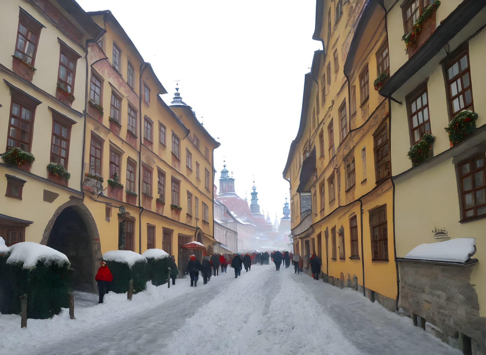 Snowy European Town Street Scene with Yellow Buildings and Red Umbrellas