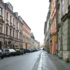 Snowy Street Scene with Vintage Cars and Festive Decorations