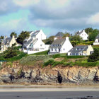 Serene medieval town by the sea with boats, white buildings, red roofs, green hills