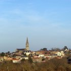 Charming village scene with orange roofs and church spires