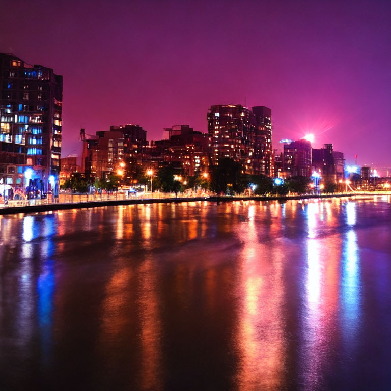 Urban skyline night view with purple skies and river reflections