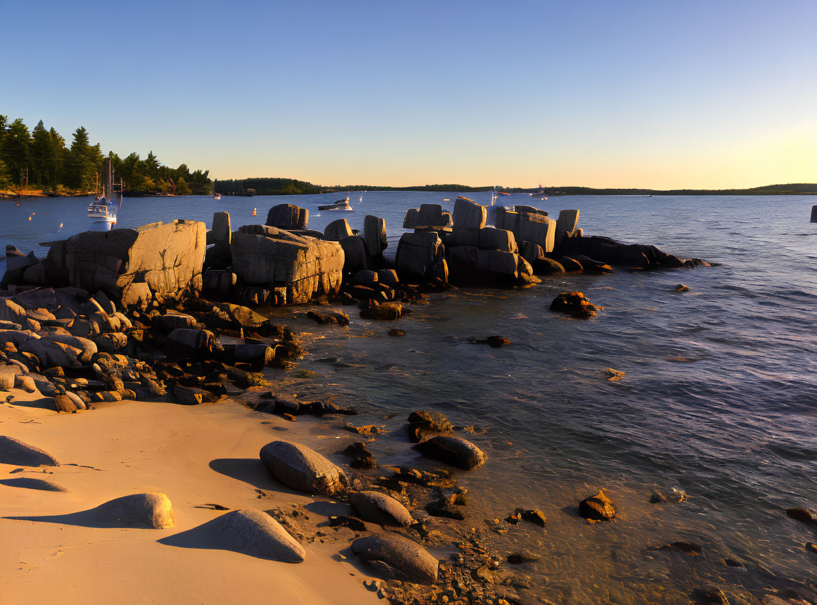 Tranquil Coastal Scene with Smooth Boulders and Anchored Boats