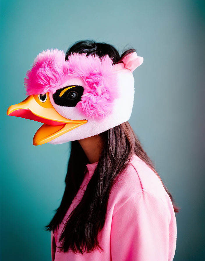 Person in Pink Shirt Wearing Flamingo Mask with Plush Feathers