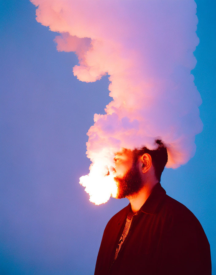 Man exhales smoke resembling fire on blue background