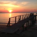 Tranquil Ocean Sunset with Wooden Pier and Birds