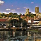 Scenic coastal town with cathedral, white buildings, and boats at sunset