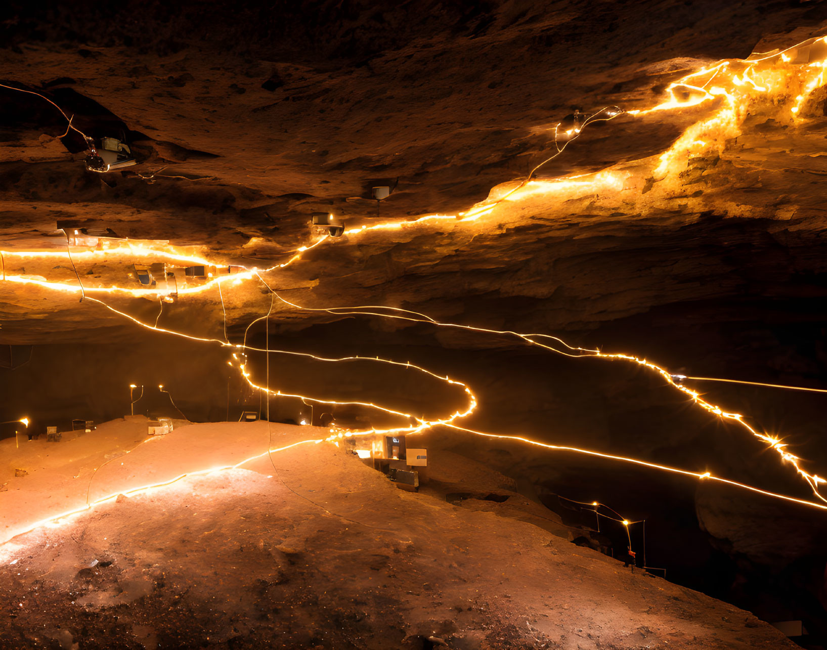 Illuminated Curving Path in Dark Cavern with Bright Lights