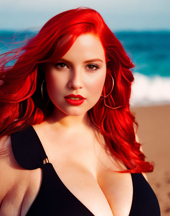 Red-haired woman in black attire at beach pose