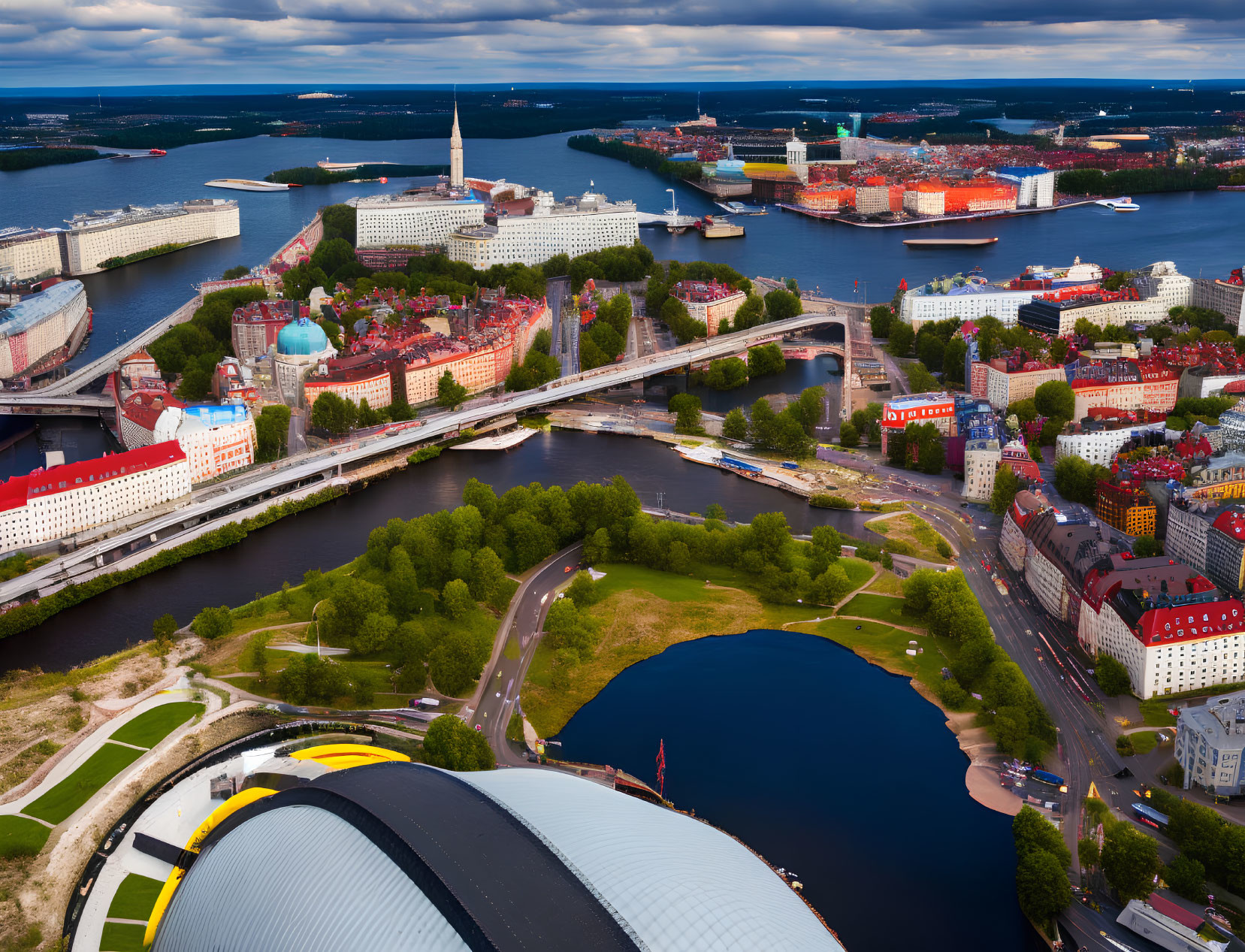 Cityscape with rivers, bridges, buildings, green spaces, and ships in port