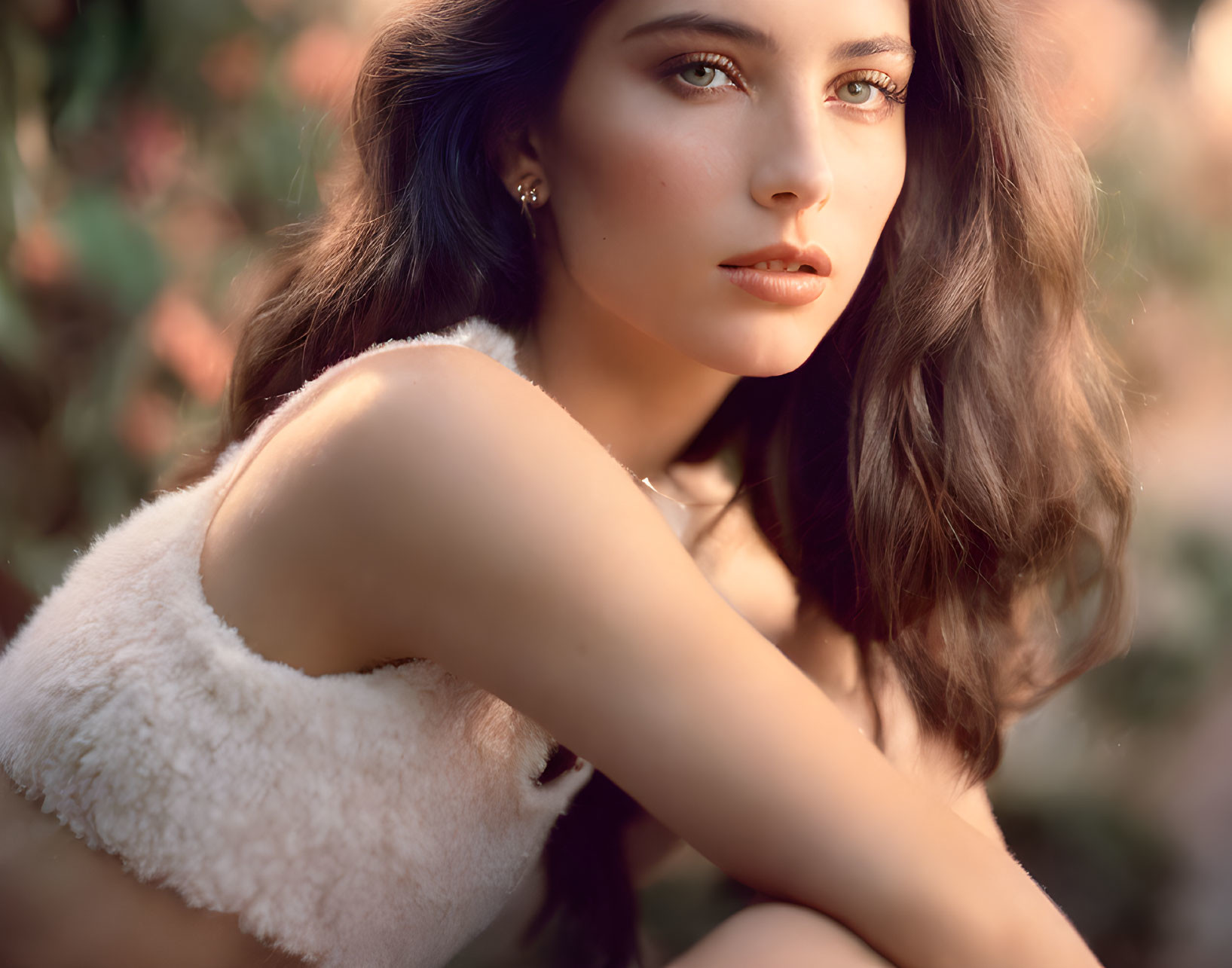 Brown-haired woman in off-shoulder top gazing away, soft-focus background