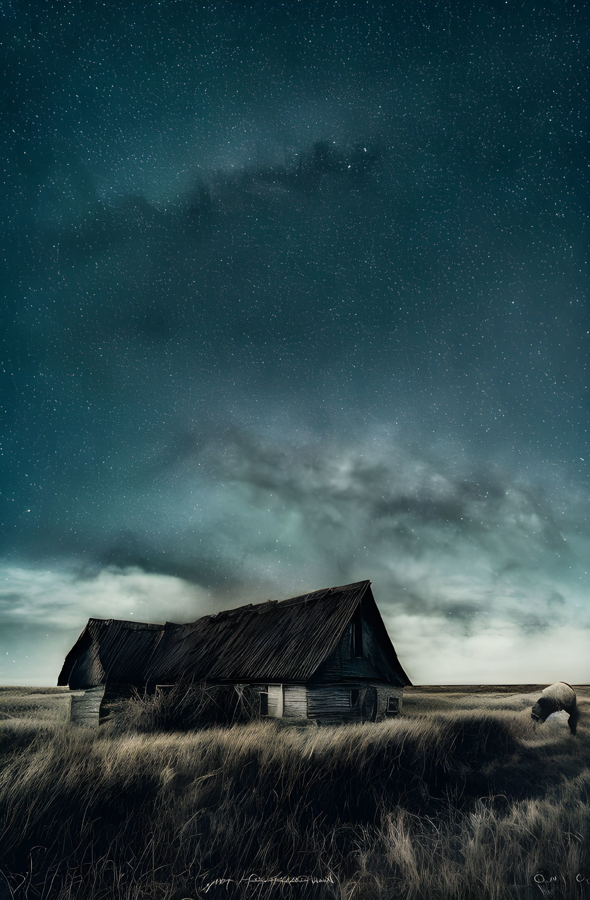 Rustic wooden barn under starry night sky with dramatic cloudscape