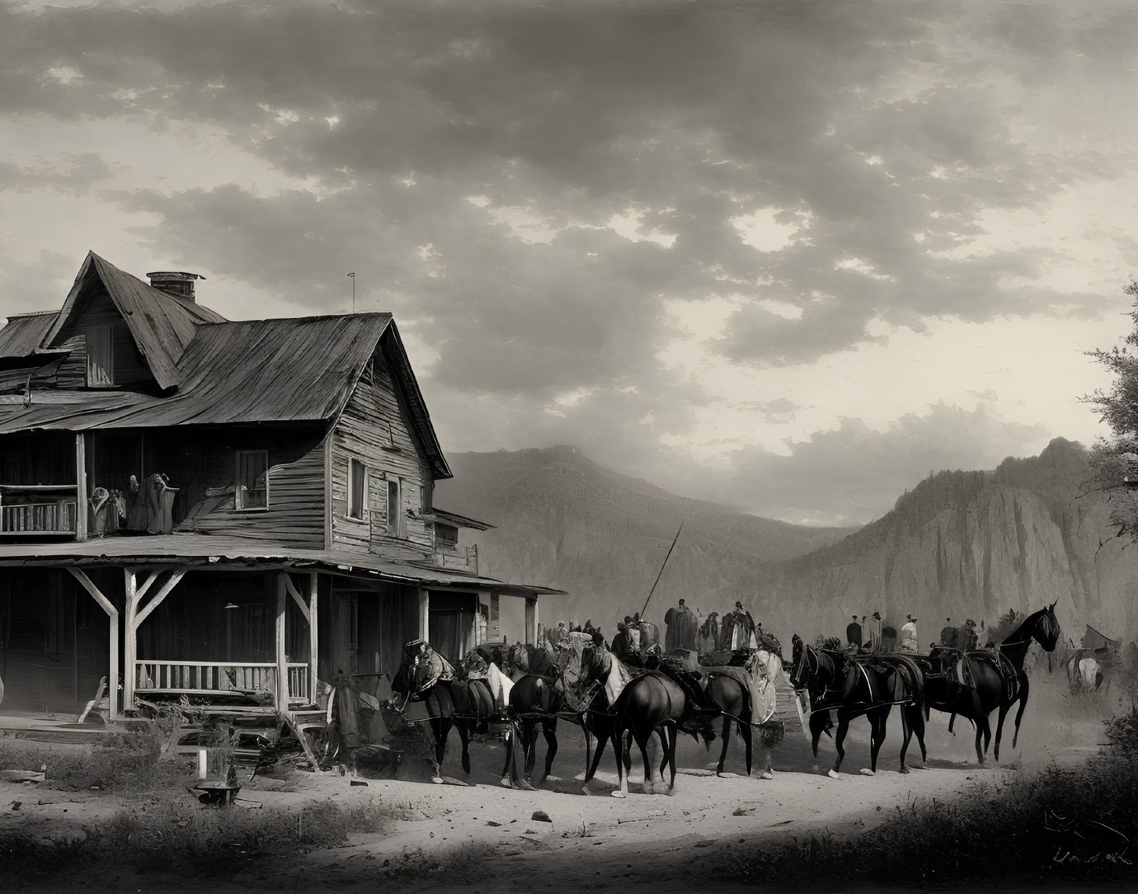 Monochrome image of horseback riders by rustic house & mountains