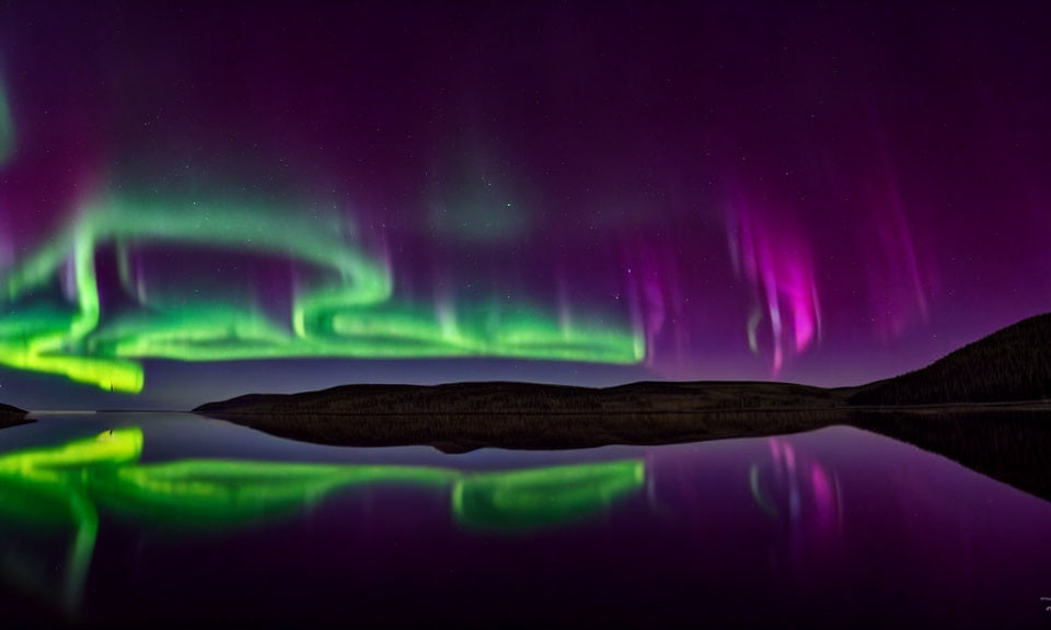 Night Sky: Green and Purple Aurora over Tranquil Lake and Silhouetted Hills