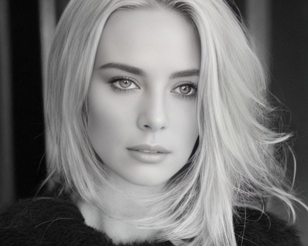 Monochrome portrait of woman with blonde hair and intense gaze