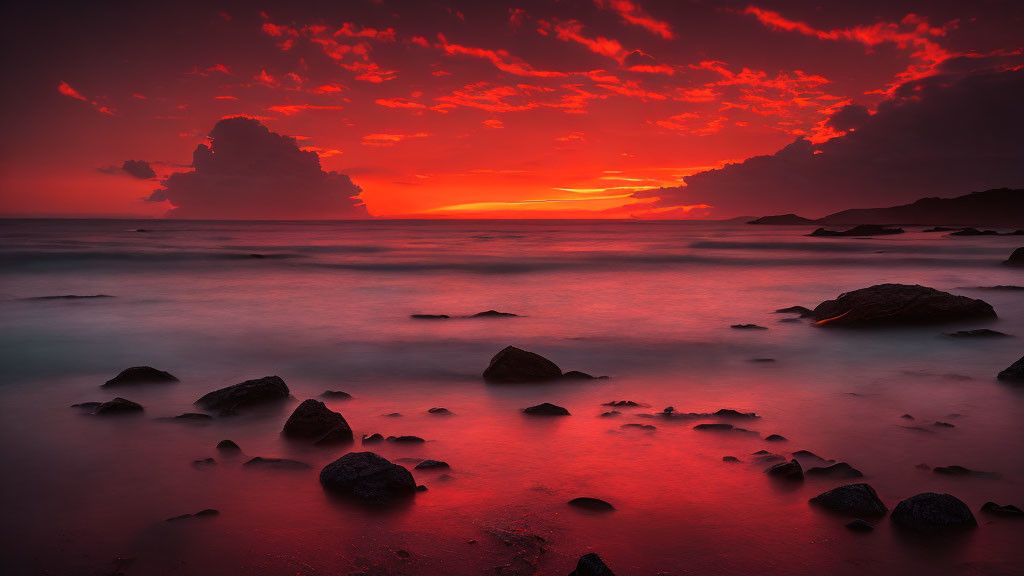 Serene beach sunset with vibrant red sky