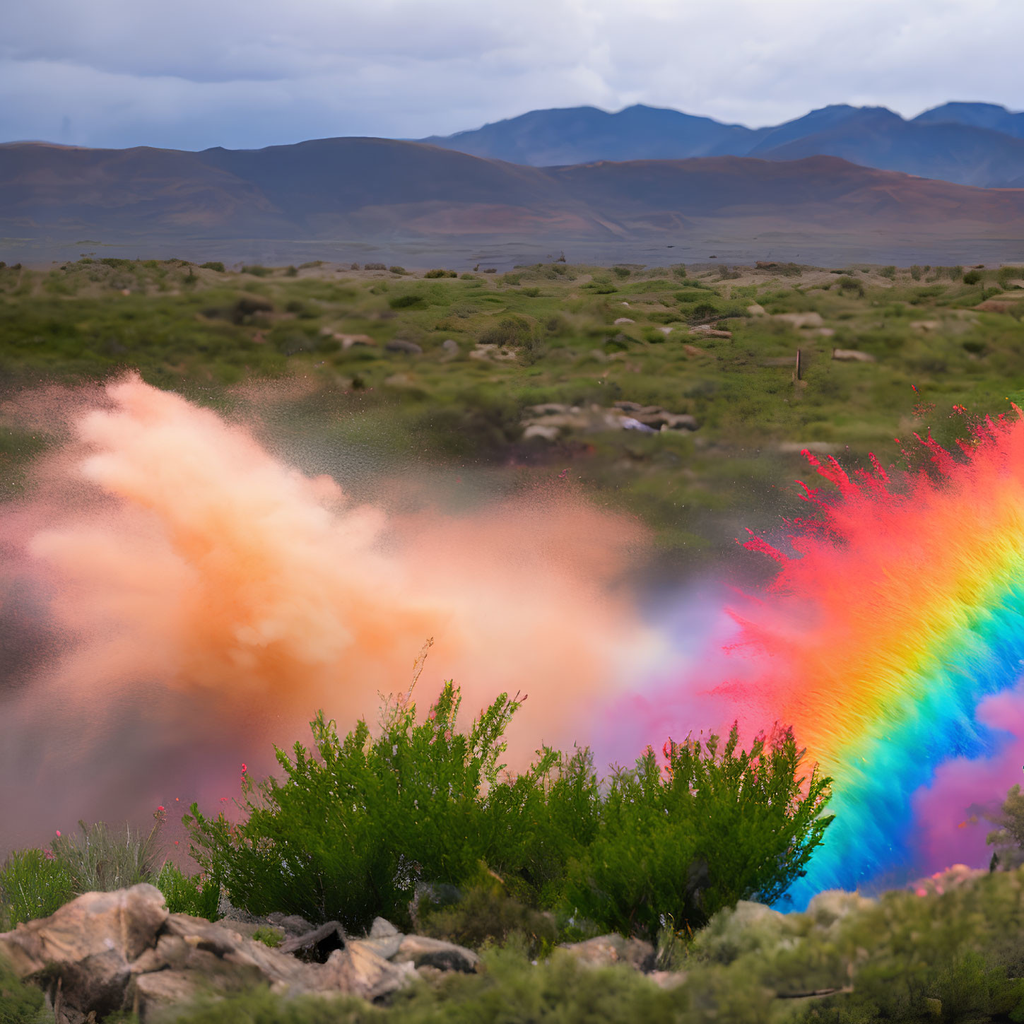 Colorful Rainbow Cloud Burst over Green Shrubs and Mountains