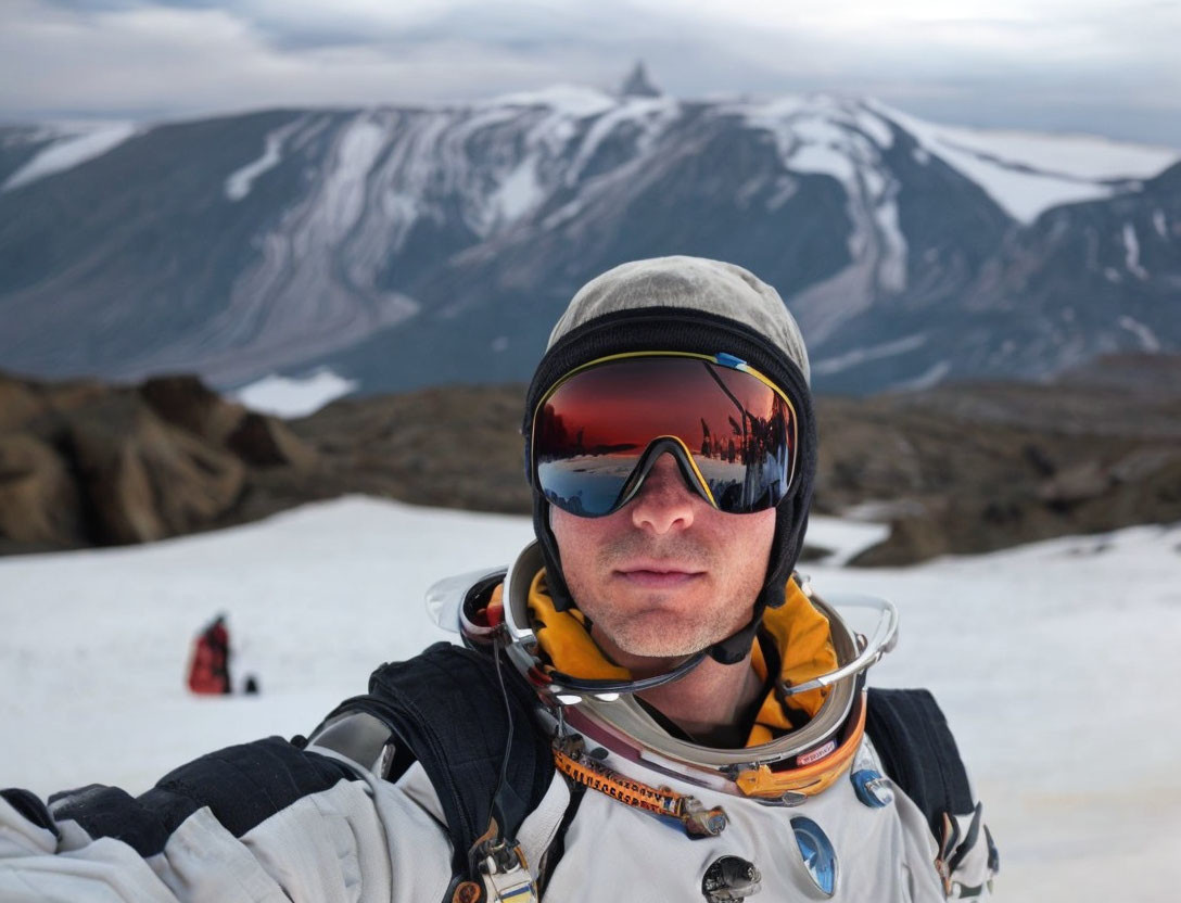 Astronaut in reflective sunglasses takes selfie with snowy mountains