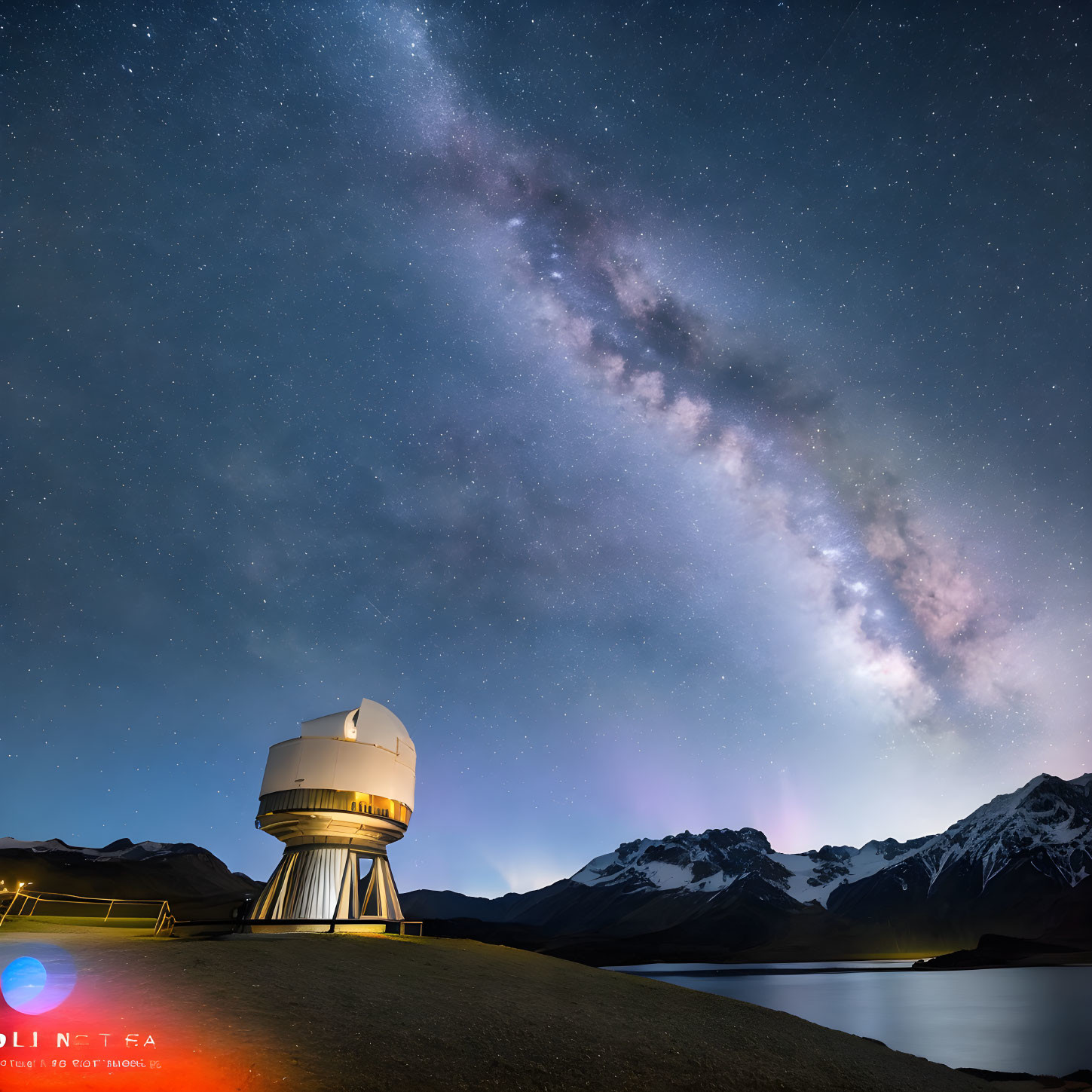 Starry sky over observatory by lake and mountains