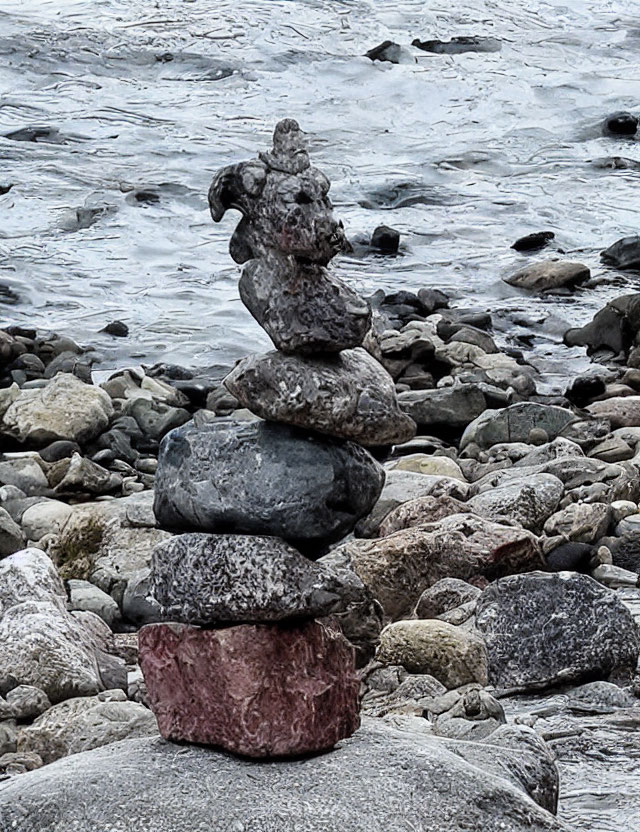 Six Rocks Balanced by Water Body with Pebbles and Waves