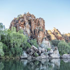 Serene Orientalist landscape with lake, boats, waterfalls, palm trees, and domed palace